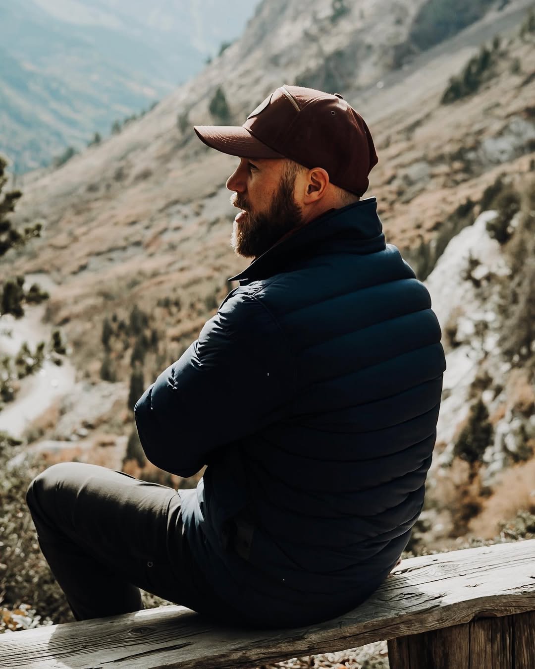 Kent sitting on a mountain overlook